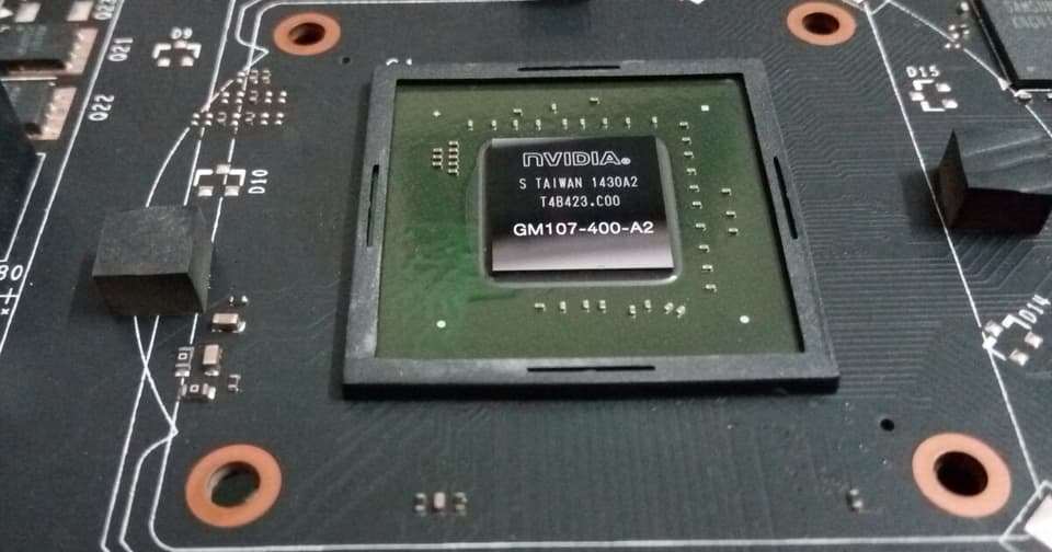 Close-up view of an NVIDIA GPU chip mounted on a green circuit board
