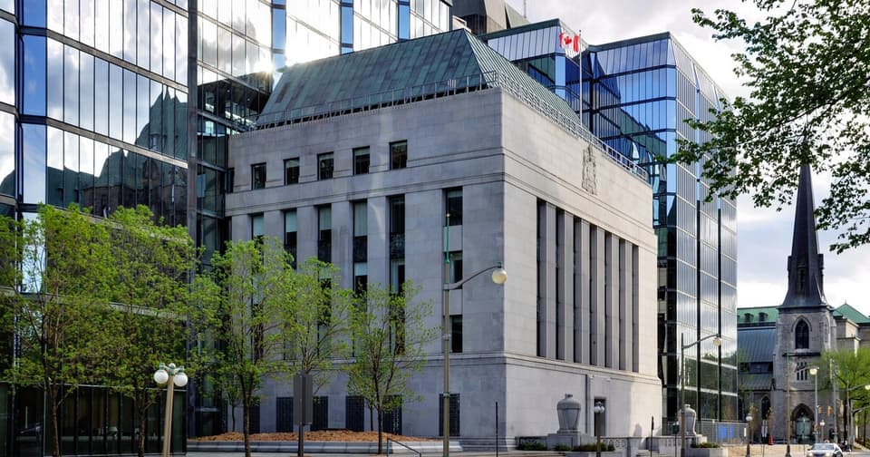 The Bank of Canada downtown building with the Canadian flag hanging.
