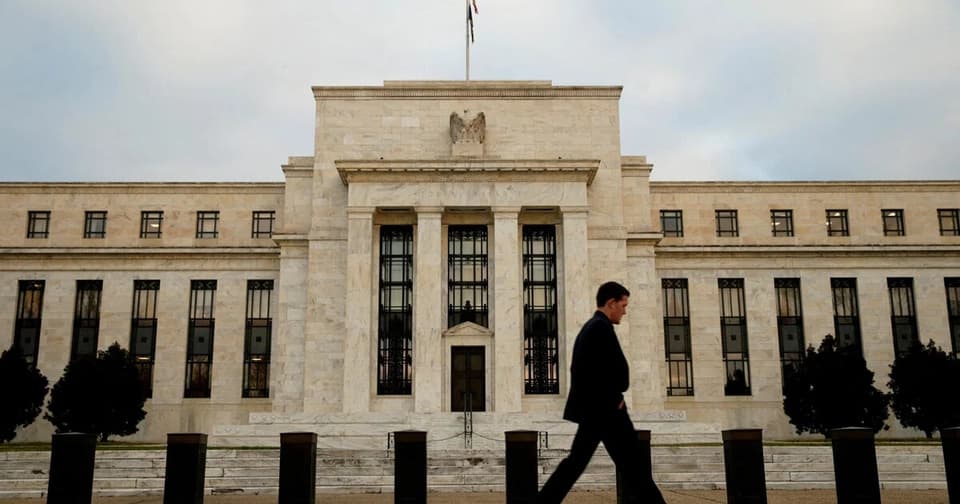 Front facade of the Federal Reserve building, a person walking in front