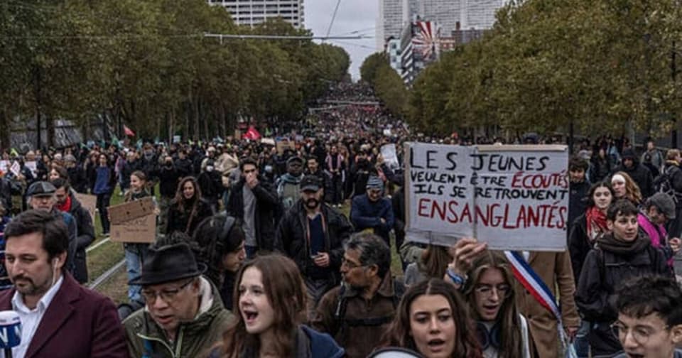 Crowded political protest in France, people carrying banners