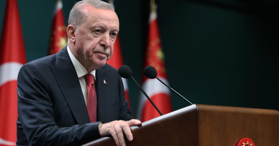 Male executive speaking at the podium with the Turkish flag in the background