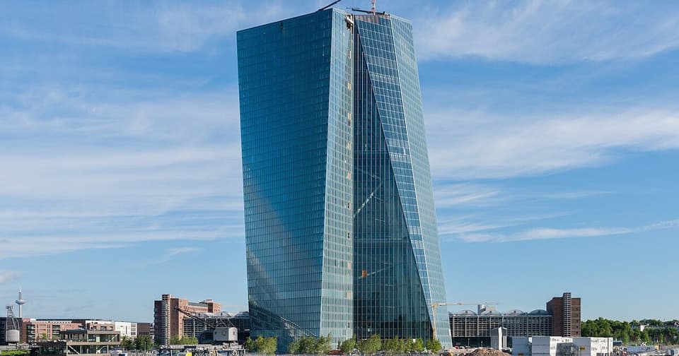 Photograph of a modern skyscraper building on the riverbank