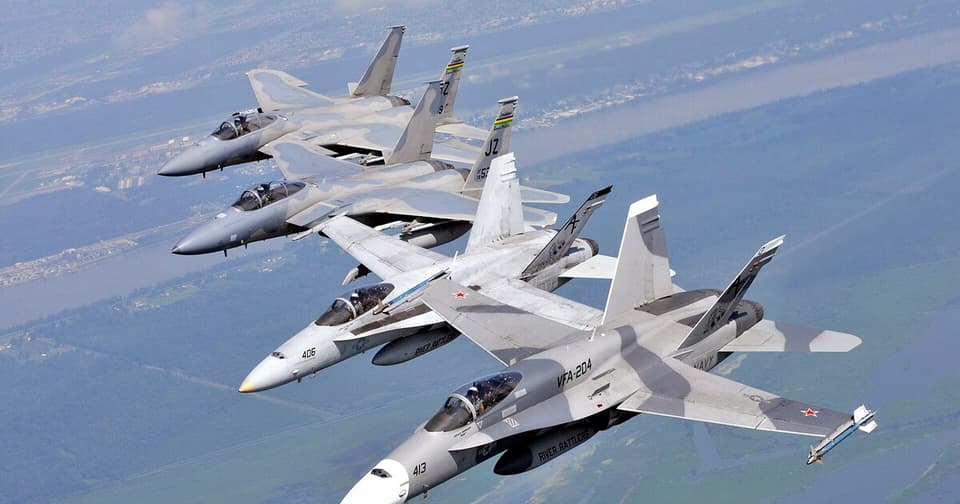 American F-15 fighter jets flying in formation in the sky.