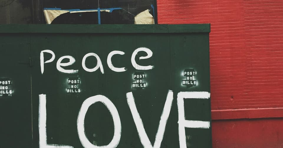Street art mural reading Peace Love